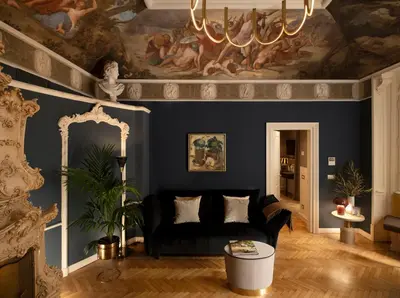 a living room with a black couch and a painting at Elizabeth Unique Hotel | a Member of Design Hotels™ in Rome