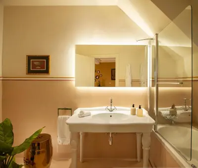a bathroom with a sink and a shower and a mirror at Elizabeth Unique Hotel | a Member of Design Hotels™ in Rome