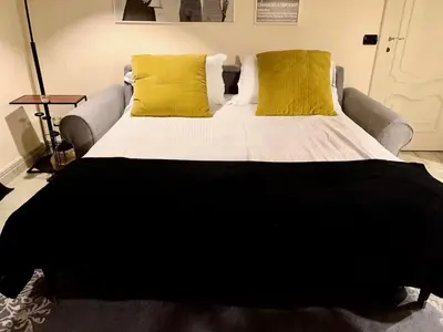 a large bed with two yellow pillows on it at Sweethome Crispi in Rome