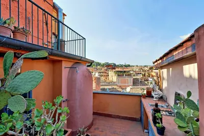 an apartment balcony with a view of a city at Vicolo del Cinque Penthouse | Romeloft in Rome