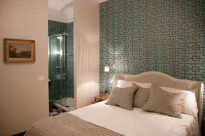 a bedroom with a bed and a glass shower at Santa Monica Townhouse in Rome