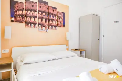 a bedroom with a bed and a painting on the wall at Viale Giulio Cesare Guest House in Rome