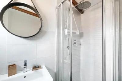 a bathroom with a shower and a sink and a mirror at Meraki in Rome