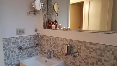 a bathroom with a sink and a mirror at Rose Roma in Rome