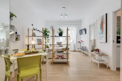 a living room with a table and chairs and a dining room at Vatican 96 Degli Ubaldi Studio steps from metro and St Peter's in Rome