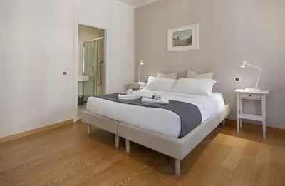 a room with a gate and a white wall at Colosseo Guest House in Rome