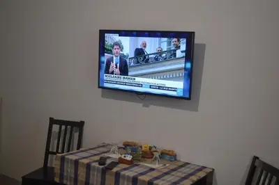a flat screen tv hanging on a wall above a table at Incantoromano guest house in Rome