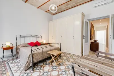 a bedroom with a bed and a table and a bench at Monti Colosseum apartment in Rome