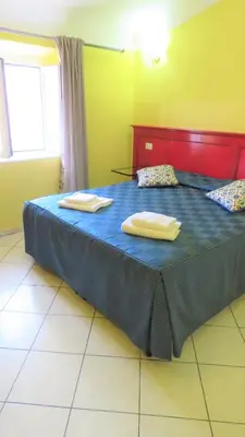 a bedroom with a bed with two towels on it at Fanti Rooms in Rome