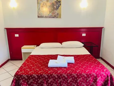 a bedroom with a bed with two towels on it at Fanti Rooms in Rome