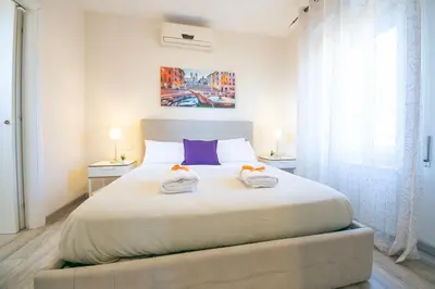 a bedroom with a large bed with two towels on it at San Peter Raffy's House in Rome