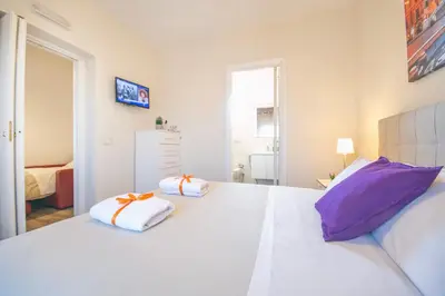 a bedroom with a large white bed with two pillows at San Peter Raffy's House in Rome