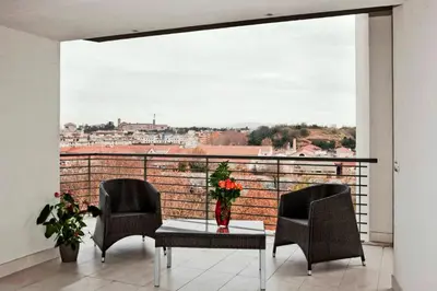 a table with a vase of flowers on a balcony at Lungotevere Suite in Rome