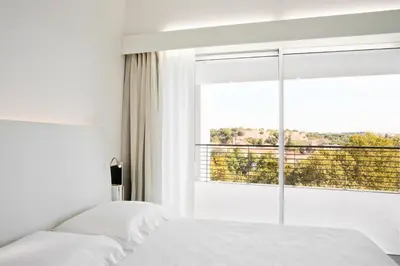 a bedroom with two beds and a large window at Lungotevere Suite in Rome