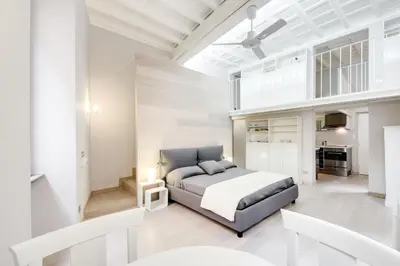a bedroom with a bed in a white room at Appartamento vicolo della Vaccarella - Pantheon in Rome
