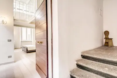 a hallway with stairs leading to a bedroom at Appartamento vicolo della Vaccarella - Pantheon in Rome