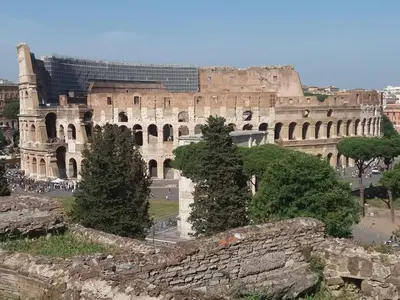 a large building with trees in front of it at Foro Romano Luxury Suites in Rome
