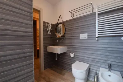 a bathroom with a white toilet and a sink at Veneto Suite Rome in Rome