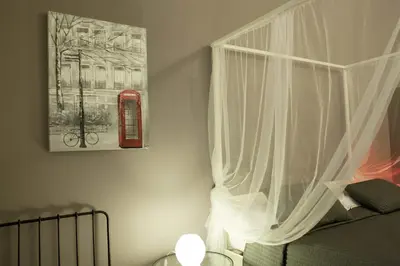 a bedroom with a bed and a red phone booth at Happy Stay Guesthouse in Rome