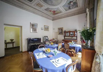 a dining room with two tables with blue table cloth at Affreschi Su Roma Luxury B&B in Rome