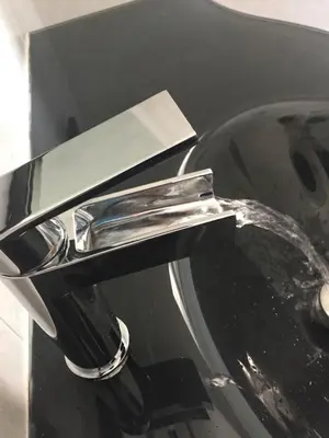 a close up of a bathroom sink with water coming out at BenS'Houses - Villa Pamphili apartment in Rome
