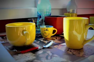 two yellow cups on a table with a spoon at World Wide Bed - Prenestino in Rome