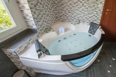 a bath tub in a bathroom with a window at World Wide Bed - Prenestino in Rome