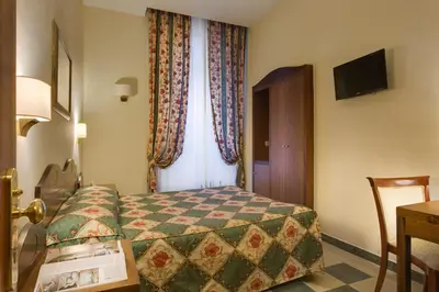 a hotel room with a bed and a window at Hotel Aberdeen in Rome