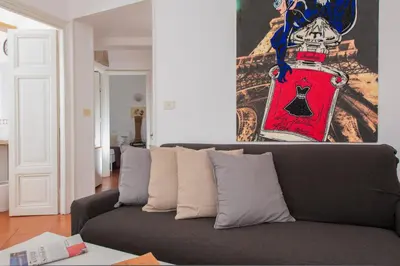 a couch in a living room with a painting on the wall at Monti Deluxe - Terrace Spectacular View in Rome