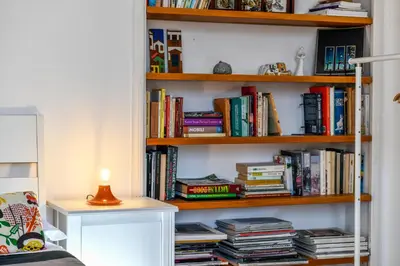 a book shelf filled with lots of books at Monti Deluxe - Terrace Spectacular View in Rome