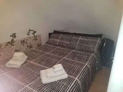a bedroom with a bed with two towels on it at barberini holiday house in Rome