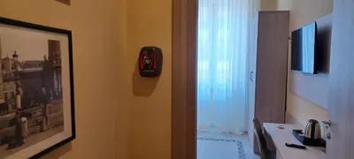 a bathroom with a door with a fire hydrant on the wall at Vatican View Rooms in Rome