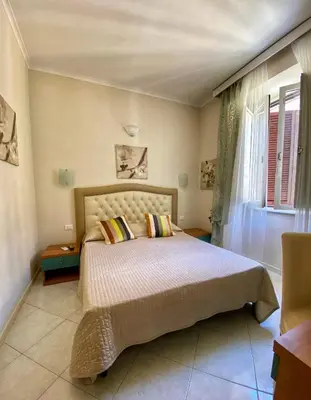 a bedroom with a large bed with flowers on it at B&B Andy&LU in Rome