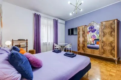a bedroom with two beds and a dining room at BigFamilyRome - Spanish Steps in Rome