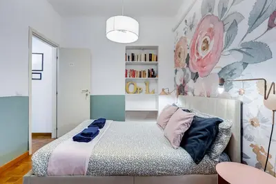 a bedroom with a bed with a flower mural on the wall at BigFamilyRome - Spanish Steps in Rome