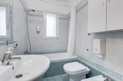 a white bathroom with a sink and a toilet at BigFamilyRome - Spanish Steps in Rome
