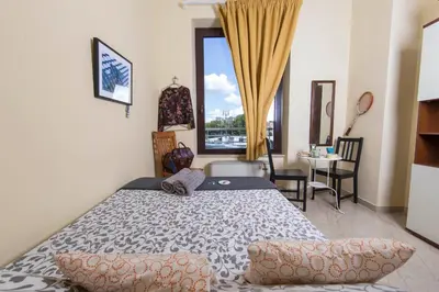 a bedroom with a bed and a large window at BigFamilyRome - Sistine Chapel in Rome