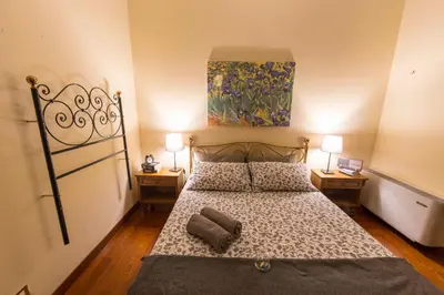 a bedroom with a bed and a painting on the wall at BigFamilyRome - Sistine Chapel in Rome
