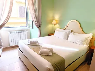 a bedroom with a large bed with towels on it at Roman Terrace in Rome