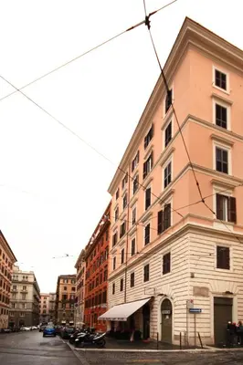 a tall building on a city street with buildings at Roman Terrace in Rome