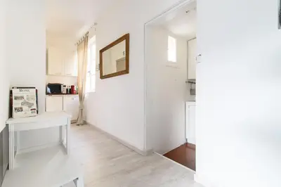 a white room with a white table and a mirror at White terrace apartment navona in Rome