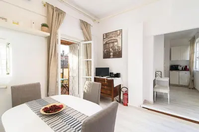 a white dining room with a table and chairs at White terrace apartment navona in Rome