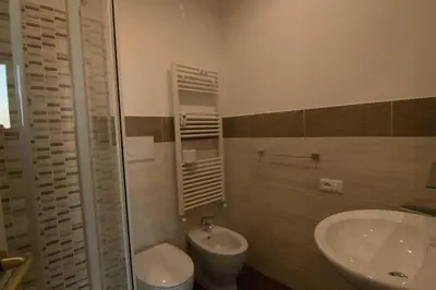 a bathroom with a sink and a toilet at La Terrazza di Evelina Guest House in Rome