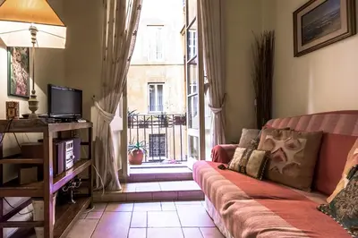 a living room with a couch and a large window at GuestHost - Palazzo Farnese Historical Home in Rome