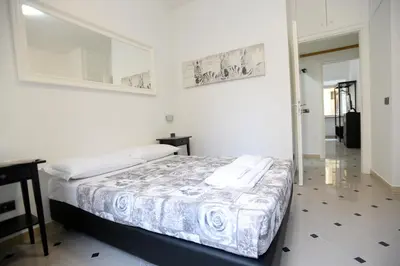 a bedroom with a bed and a table and a mirror at Casa Andrew in Rome