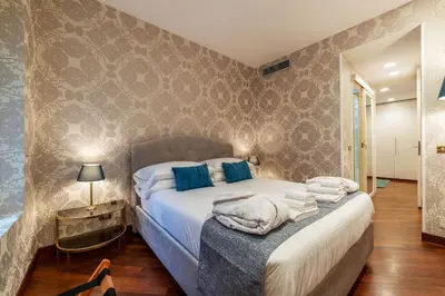 a bedroom with a bed with towels on it at Piazza di Spagna 90 Exclusive Apartment in Rome
