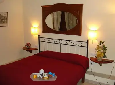 a bedroom with a red bed with a mirror on the wall at B&B La Casa Di Rosy in Rome
