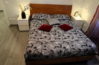 a bed with two red pillows in a bedroom at Sweet home Appio Latino in Rome