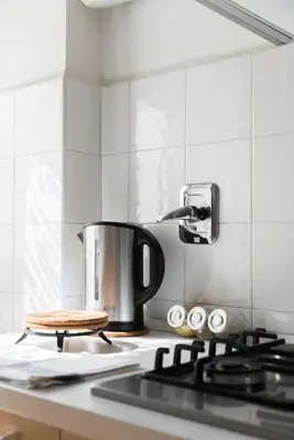 a tea kettle sitting on top of a stove in a kitchen at Casa Giramondo in Rome