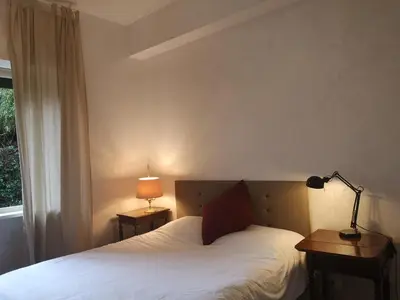 a bedroom with a bed with a lamp and a window at Cadlolo Luxury Retreat - Rome Cavalieri and Villa Miani in Rome
